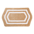 Hexagonal bath mat with beige center and white border on a white background